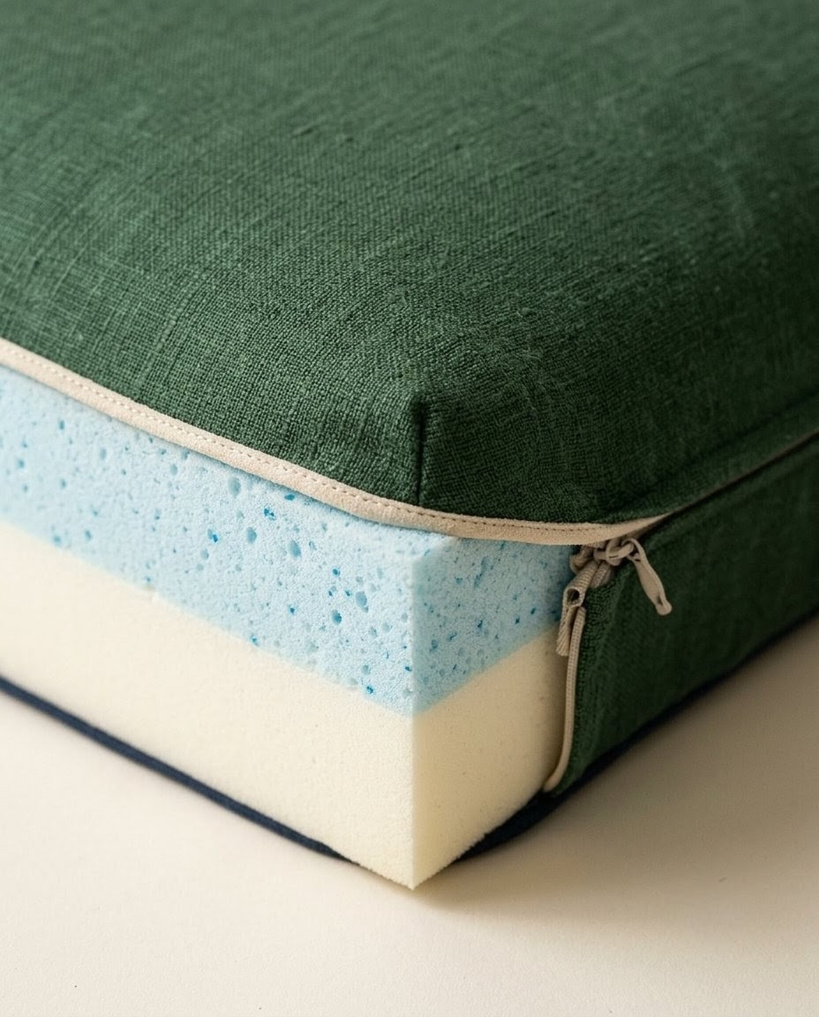 Macro of the Olloy bed layered construction: linen cover, memory foam, support base